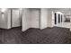 Modern hallway with patterned carpet, neutral walls, and unit entrances at 260 S Osceola Ave # 1207, Orlando, FL 32801