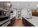 Modern kitchen with stainless steel appliances, white countertops, and dark wood cabinetry at 260 S Osceola Ave # 1207, Orlando, FL 32801