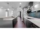 Modern kitchen featuring stainless steel appliances, dark cabinetry, mosaic backsplash, and a breakfast bar at 260 S Osceola Ave # 1207, Orlando, FL 32801