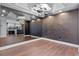 Modern living room with hardwood floors, mirrored wall, and a glimpse of the kitchen at 260 S Osceola Ave # 1207, Orlando, FL 32801