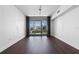 Bright living room with hardwood floors, large windows, and views of the city skyline at 260 S Osceola Ave # 1207, Orlando, FL 32801