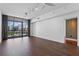 Open-concept living room with hardwood floors, city views, and a ceiling fan at 260 S Osceola Ave # 1207, Orlando, FL 32801