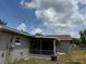 Backyard view featuring a screened-in porch extending from the house at 2747 Rose Moss Ln, Orlando, FL 32807
