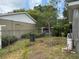 The backyard has green lawn, a chain-link fence, and a storage shed at 2747 Rose Moss Ln, Orlando, FL 32807
