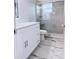 Elegant bathroom with a stylish vanity and a glass-enclosed shower showcasing marble-style tile at 2747 Rose Moss Ln, Orlando, FL 32807