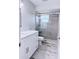 Modern bathroom featuring gray tiling in the shower and a white vanity with gray stone counters at 2747 Rose Moss Ln, Orlando, FL 32807
