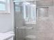 Modern bathroom featuring frameless shower, marble tile, and sleek fixtures at 2747 Rose Moss Ln, Orlando, FL 32807