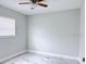 Cozy bedroom with fan, window, and marble-style flooring at 2747 Rose Moss Ln, Orlando, FL 32807