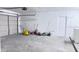 Spacious garage with a white brick wall with a garage door and a side entrance door at 2747 Rose Moss Ln, Orlando, FL 32807