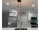 Modern kitchen with stainless steel appliances, white cabinets, a center island, and stylish light fixtures at 2747 Rose Moss Ln, Orlando, FL 32807