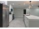 Modern kitchen with stainless steel appliances, white cabinets, and a center island with quartz countertops at 2747 Rose Moss Ln, Orlando, FL 32807