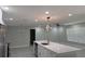 Modern kitchen with stainless steel appliances, white cabinets, and a center island with quartz countertops at 2747 Rose Moss Ln, Orlando, FL 32807
