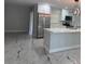 Modern kitchen with stainless steel appliances, white cabinets, and a center island with quartz countertops at 2747 Rose Moss Ln, Orlando, FL 32807