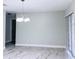 Open living room featuring marble floors, natural light, and modern chandelier at 2747 Rose Moss Ln, Orlando, FL 32807
