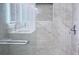 Marble shower featuring glass door and chrome fixtures at 2747 Rose Moss Ln, Orlando, FL 32807