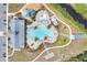 Overhead view of community pool area with large pool, splashpad, lounging areas, clubhouse, and parking at 2834 Common Crane Ct, St Cloud, FL 34773