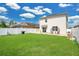 Spacious fenced backyard featuring green grass and a two-story home at 2834 Common Crane Ct, St Cloud, FL 34773