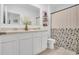 Bathroom featuring double sinks, framed mirror, and floral shower curtain at 2834 Common Crane Ct, St Cloud, FL 34773
