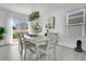 Dining area with neutral decor, a modern chandelier and a sliding glass door at 2834 Common Crane Ct, St Cloud, FL 34773