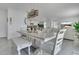 Dining area with a modern chandelier, open to the living room and kitchen at 2834 Common Crane Ct, St Cloud, FL 34773