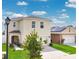 Two-story home with a manicured lawn and front porch in a suburban neighborhood at 2834 Common Crane Ct, St Cloud, FL 34773