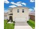Traditional two-story home with a two-car garage, well-maintained lawn, and neutral color palette at 2834 Common Crane Ct, St Cloud, FL 34773