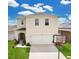 Two-story home with neutral siding, an attached garage and basketball hoop in the front yard at 2834 Common Crane Ct, St Cloud, FL 34773