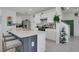 Modern kitchen with stainless steel appliances, white cabinets, and a breakfast bar at 2834 Common Crane Ct, St Cloud, FL 34773