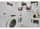 Well-organized laundry room with front load washer and dryer at 2834 Common Crane Ct, St Cloud, FL 34773