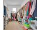 Spacious walk-in closet with ample storage and shelving for shoes, boxes, and personal belongings at 2834 Common Crane Ct, St Cloud, FL 34773