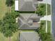 An aerial view displays the roof and landscaping of a well-maintained residential property at 2956 White Cedar Cir, Kissimmee, FL 34741