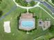 Aerial view featuring a community pool, playground, and well-manicured landscaping at 2956 White Cedar Cir, Kissimmee, FL 34741