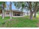Expansive backyard showcasing a covered patio ideal for outdoor living and entertaining at 2956 White Cedar Cir, Kissimmee, FL 34741