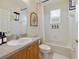 Well-organized bathroom featuring a shower/tub combo and oak vanity and a framed print at 2956 White Cedar Cir, Kissimmee, FL 34741