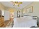 Comfortable bedroom with an arched doorway, wood-look floors, and a ceiling fan at 2956 White Cedar Cir, Kissimmee, FL 34741