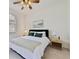 Cozy bedroom with a bed dressed in white linens, complemented by a decorative throw at 2956 White Cedar Cir, Kissimmee, FL 34741