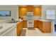 A bright kitchen features stainless steel appliances, lots of counter space, and wood cabinets at 2956 White Cedar Cir, Kissimmee, FL 34741