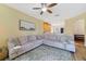 A comfortable living room with a large sectional sofa, an open floor plan, and access to the kitchen at 2956 White Cedar Cir, Kissimmee, FL 34741