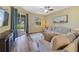 A comfortable living room with large sectional sofa, access to the patio, and lots of natural light at 2956 White Cedar Cir, Kissimmee, FL 34741