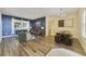 A well-decorated living room with dining area, hardwood floors, stylish rug, and modern furniture at 2956 White Cedar Cir, Kissimmee, FL 34741