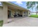 Covered outdoor patio featuring patio furniture and a grill, perfect for outdoor living at 2956 White Cedar Cir, Kissimmee, FL 34741