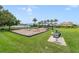 Community playground featuring swings, slides, and picnic seating amidst lush green lawns and palm trees at 2956 White Cedar Cir, Kissimmee, FL 34741