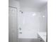 Bathroom features all-white tile, updated vanity and new fixtures at 30101 Pga Dr, Sorrento, FL 32776