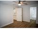 Neutral-toned bedroom featuring hardwood floors, a ceiling fan and a closet at 30101 Pga Dr, Sorrento, FL 32776