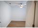 Small bedroom with new hardwood floors, neutral paint, and a ceiling fan at 30101 Pga Dr, Sorrento, FL 32776