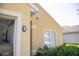 Close up on the exterior features neutral paint, a garage, and well-maintained landscaping at 30101 Pga Dr, Sorrento, FL 32776