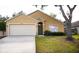 Charming single-story home featuring a two-car garage, landscaped yard and a neutral-toned exterior at 30101 Pga Dr, Sorrento, FL 32776