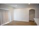 Bright living room with hardwood floors, neutral walls, and natural light from the sliding glass door at 30101 Pga Dr, Sorrento, FL 32776
