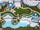 Aerial view of the resort featuring lush landscaping, pools, walking paths, and sunbathing areas at 3062 Pirate Way, Kissimmee, FL 34747