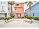Backyard with hot tub, patio dining, colorful exterior and beach chairs at 3062 Pirate Way, Kissimmee, FL 34747